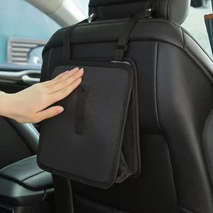 Hand resting on the front panel of a hanging car bag