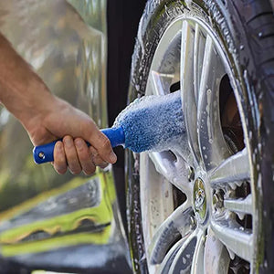 Hand using a microfiber brush on a wheel
