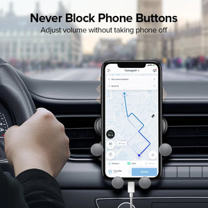 Phone holder positioned beside a steering wheel