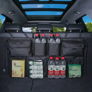 Hanging trunk organizer behind rear-seat headrests