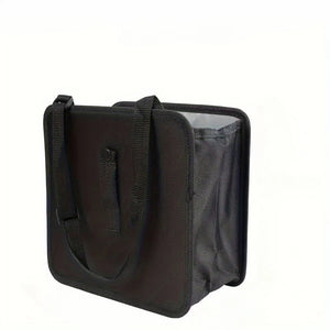 Black car bag with strap and side mesh pocket on a white background