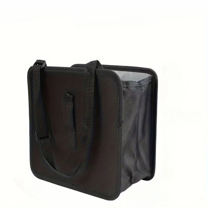 Black car bag with strap and side mesh pocket on a white background