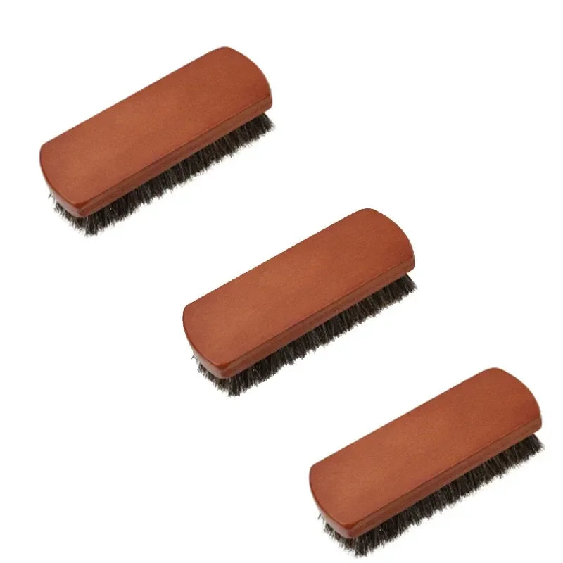 Three wood-toned cleaning brushes shown together
