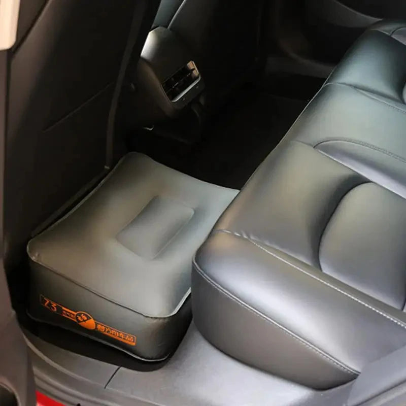 Block-style inflatable cushion behind a front seat